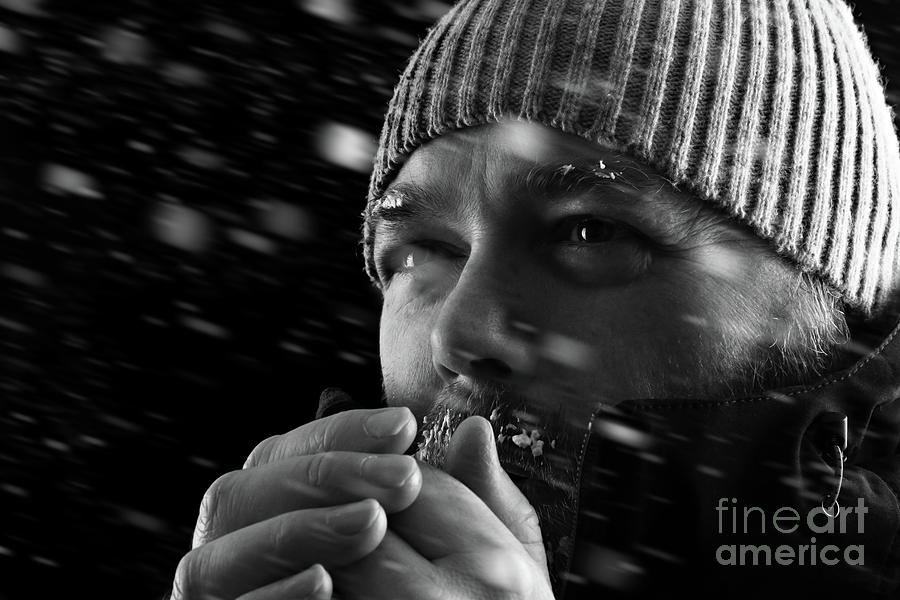 Man freezing in snow storm BW Photograph by Simon Bratt