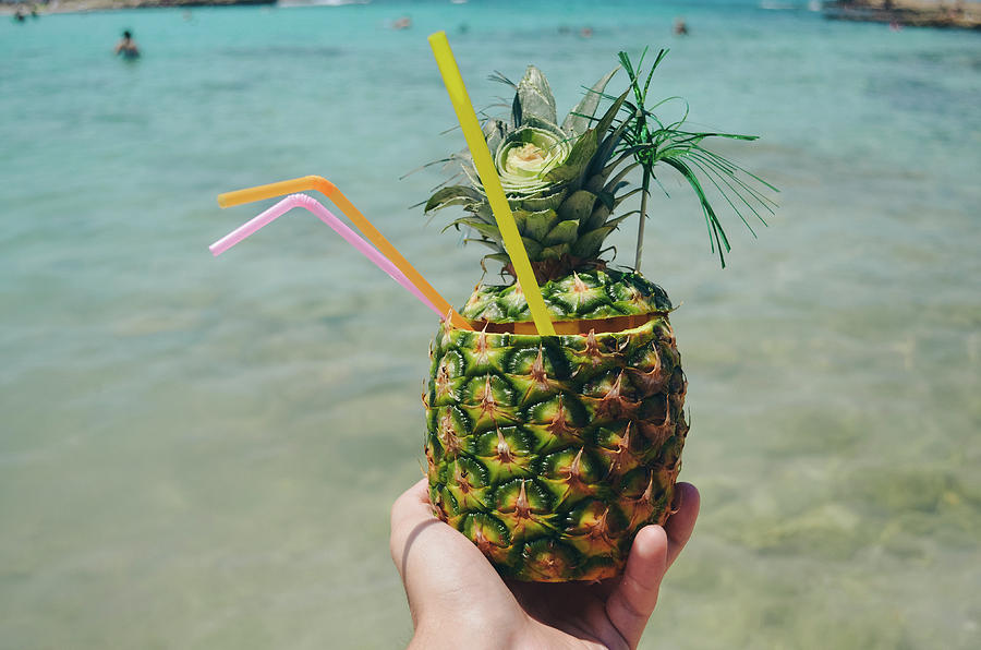 Man hand holding exotic pineapple cocktail Photograph by Alexandru ...