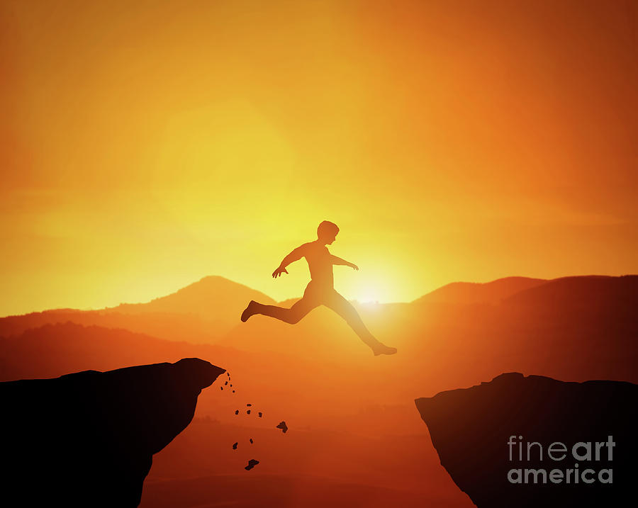 Man jumping from one rock to another. Sunset mountains scenery Photograph by Michal Bednarek