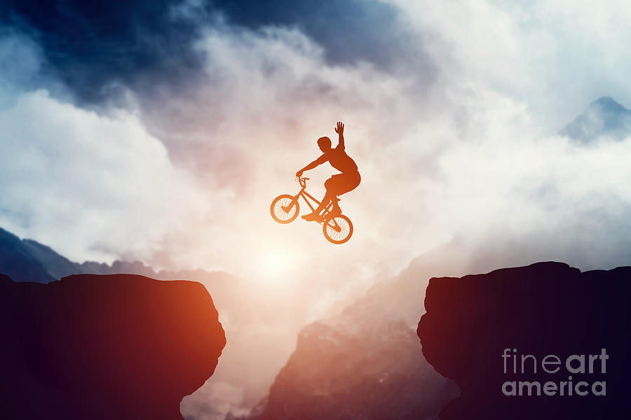 Man jumping on bmx bike over precipice in mountains at sunset Photograph by Michal Bednarek