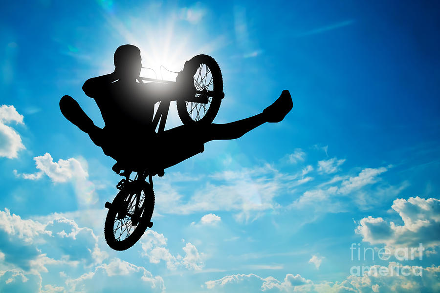 Bicycle Photograph - Man jumping on bmx bike performing a trick against sunny sky by Michal Bednarek