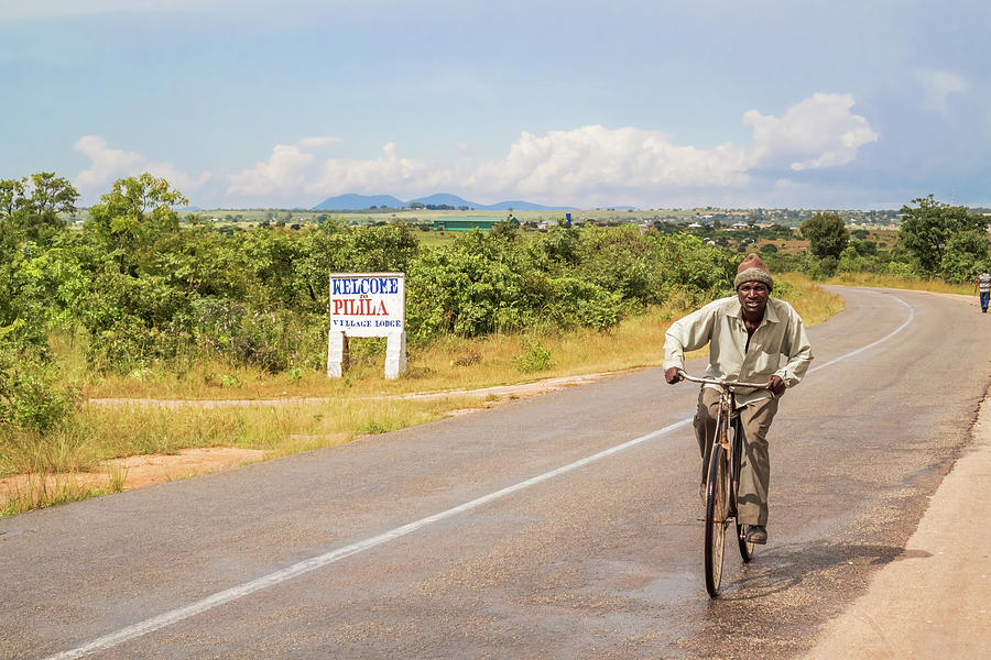 Man on bicycle in Zambia Photograph by Marek Poplawski