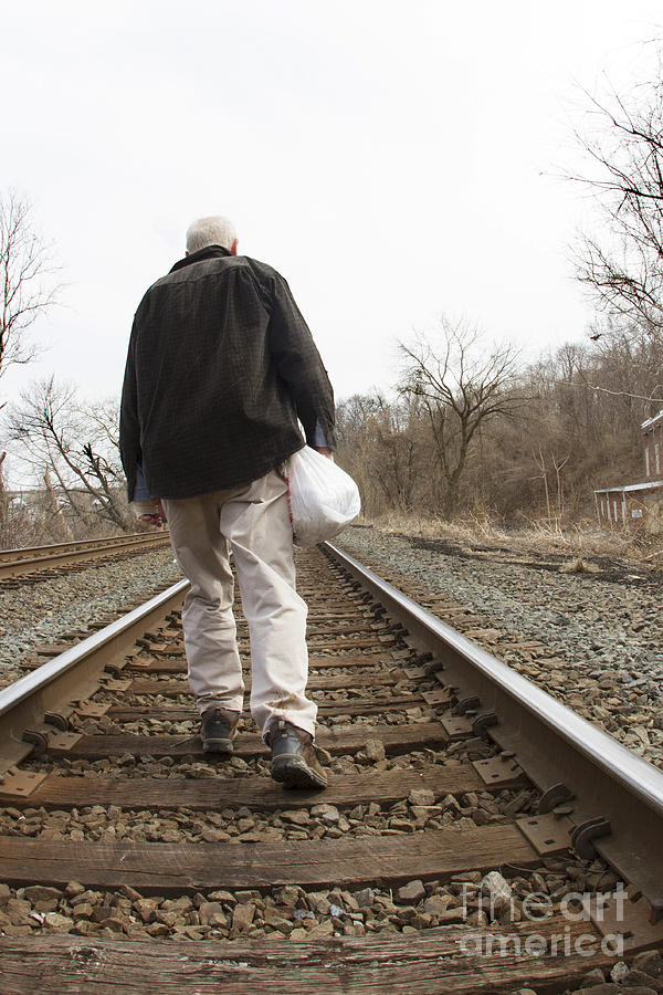 Man on railroad tracks Photograph by Karen Foley