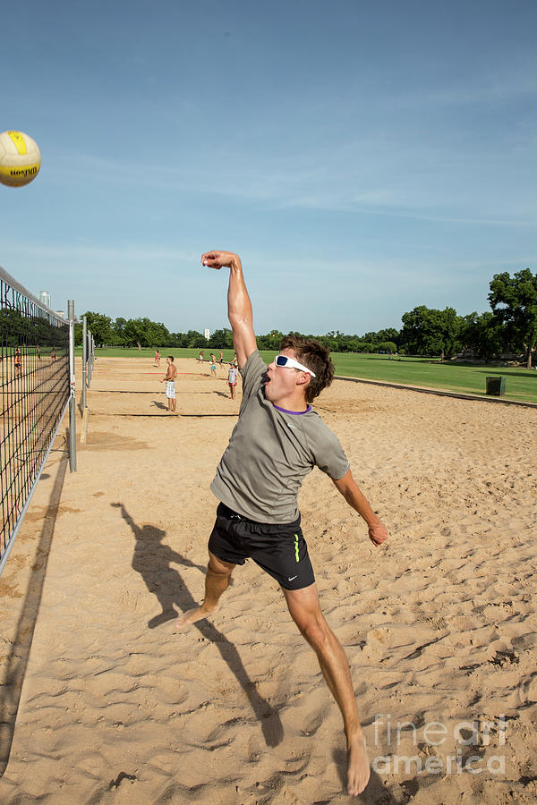 Summer Photograph - Man playing beach volleyball diving after the ball under a clear blue sky at Zilker Park sand volleyball courts by Dan Herron