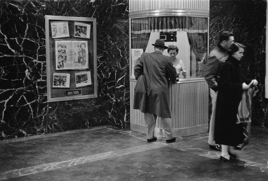 Movie Photograph - Man Purchasing A Movie Ticket by Everett