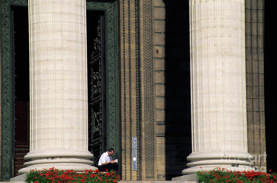 Man reading a book beside the columns of La Madeleine church in Paris Photograph by Sami Sarkis