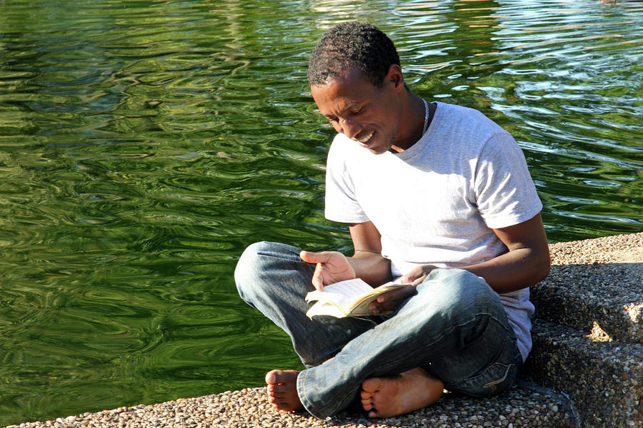 Man Reading By Green Water Photograph by Cora Wandel