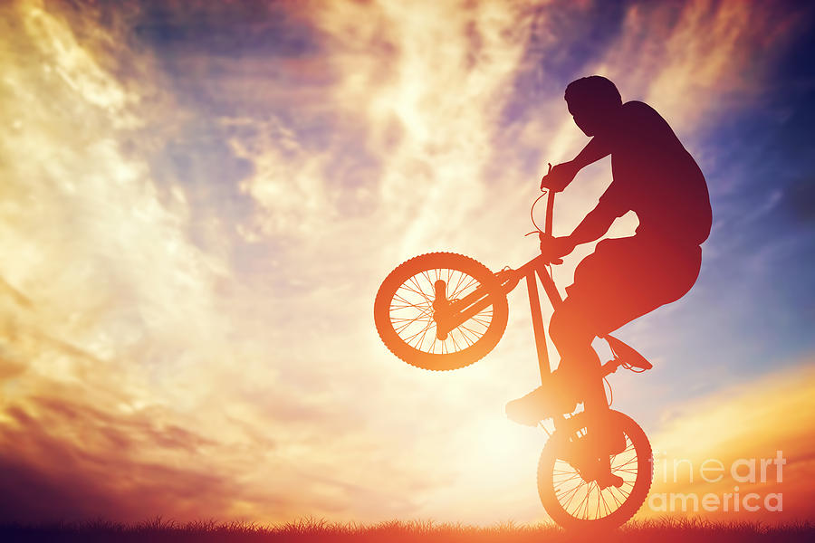 Sports Photograph - Man riding a bmx bike performing a trick against sunset sky by Michal Bednarek