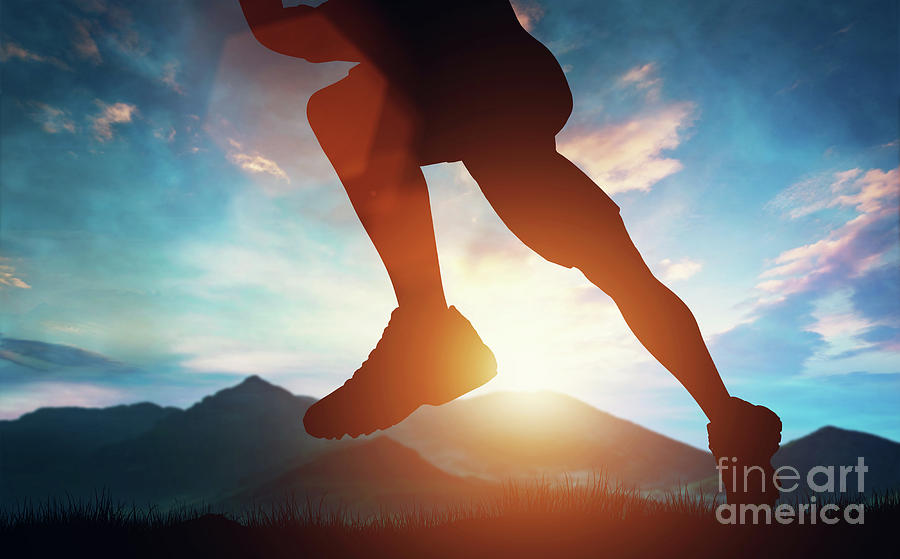 Man Running In The Mountains At The Sunset. Photograph