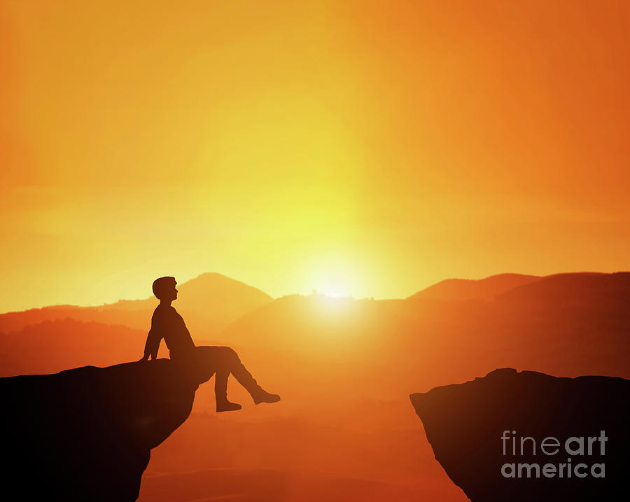 Man sitting relaxed on the edge of mountain looking at scenic sunset skyline. Photograph by Michal Bednarek