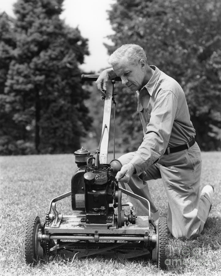 Man Tinkering With Lawnmower, C.1940s Photograph by H. Armstrong Roberts/ClassicStock