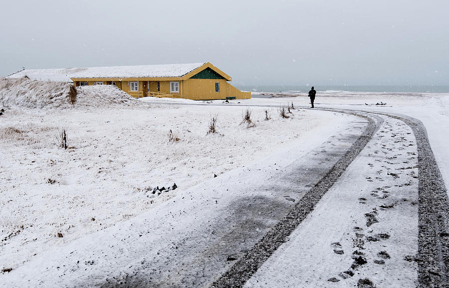 Man walking in snow Iceland Photograph by Michalakis Ppalis
