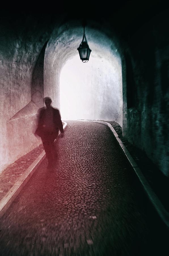 Man walking through a tunnel Photograph by Carlos Caetano