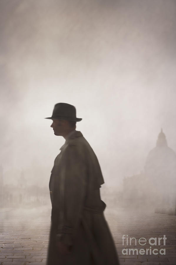 Man Wearing A Vintage Mackintosh And Fedora Walking In Fog Photograph by Lee Avison