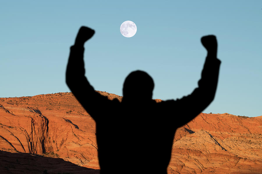 Man With Raised Arms In Desert Canyon Photograph