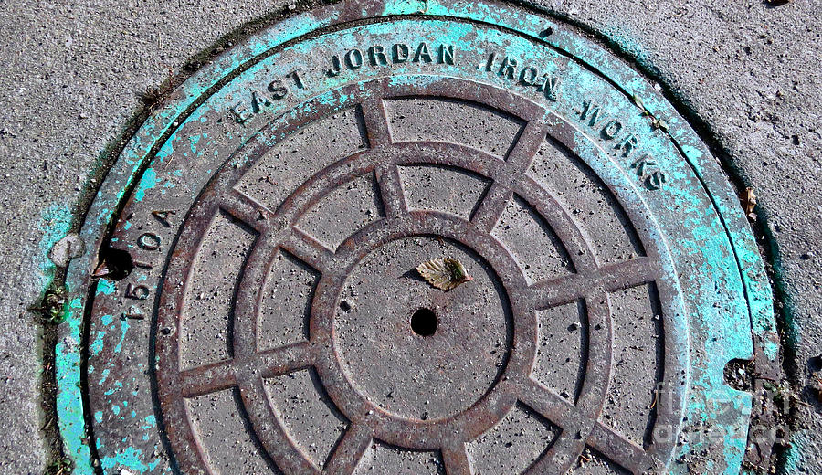 Manhole cover with turquoise Photograph by Sandra Church