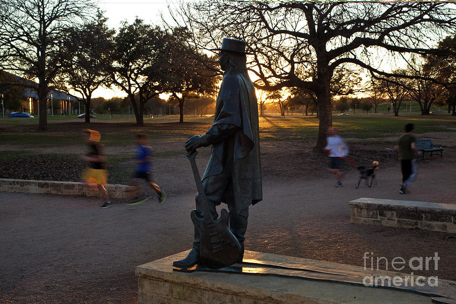 Stevie Ray Vaughan Photograph - Many Austinites take advantage of the Lady Bird Lake Hike and Bike Trail to keep fit by walking running or biking by Dan Herron