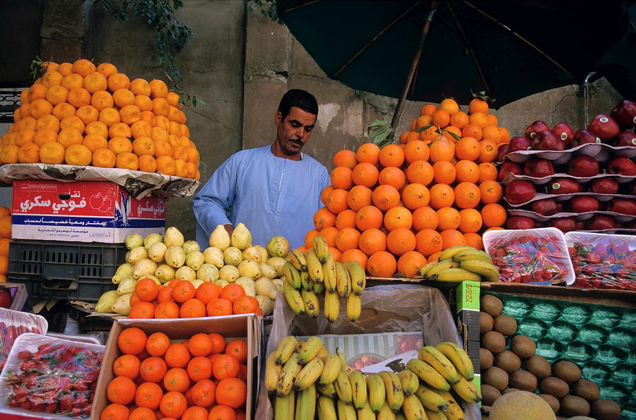 Market vendor selling fruit in a bazaar Photograph by Sami Sarkis
