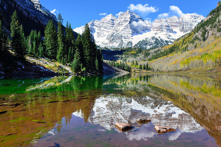 Maroon Bells during foliage season with snow covered mountains and ...