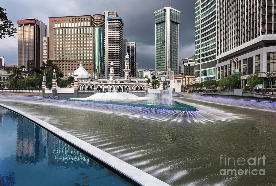 Masjid Jamek and bank towers by the Klang river in the heart of  Photograph by Didier Marti