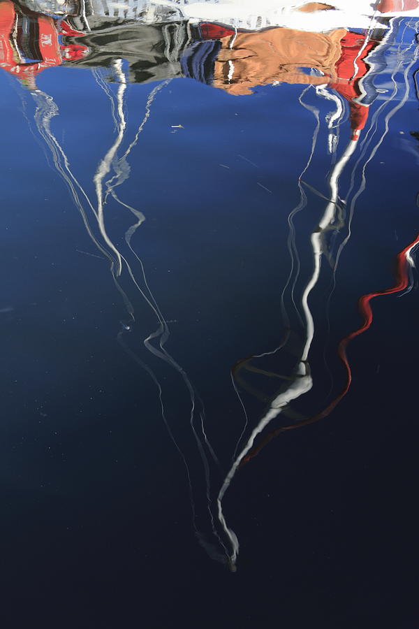 Masts of a sailing yacht reflected in the water of a bay Photograph by Ulrich Kunst And Bettina Scheidulin