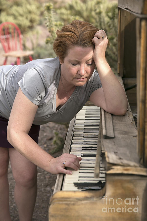 Mature Woman Playing Antique Wooden Piano In Desert Setting Photograph