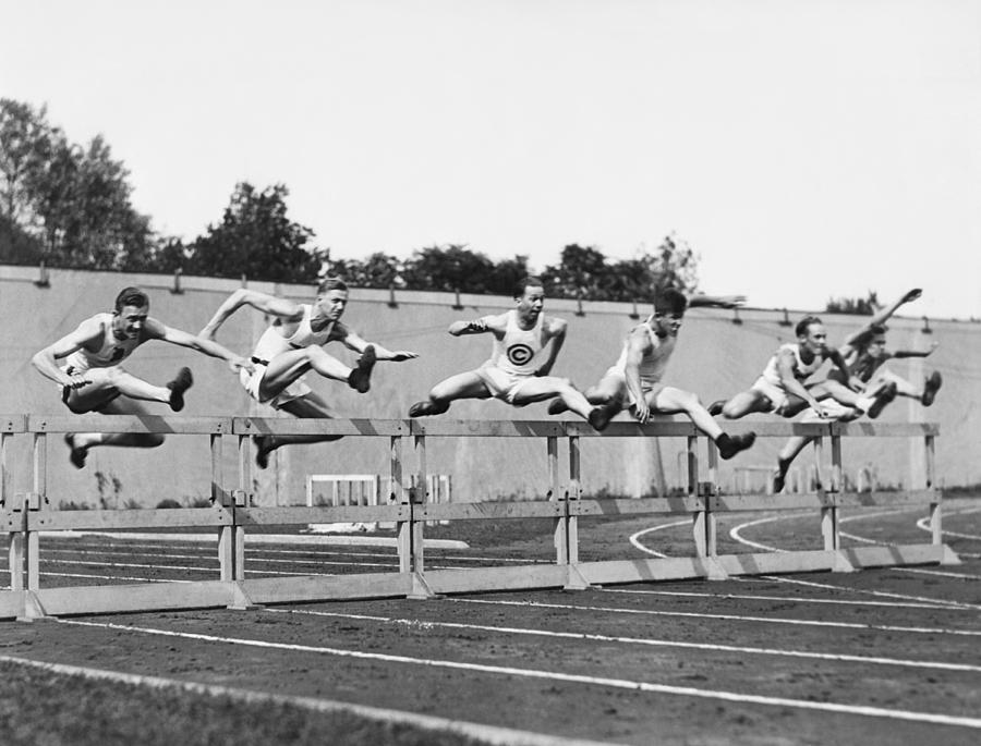 Men Running High Hurdles Photograph by Underwood Archives
