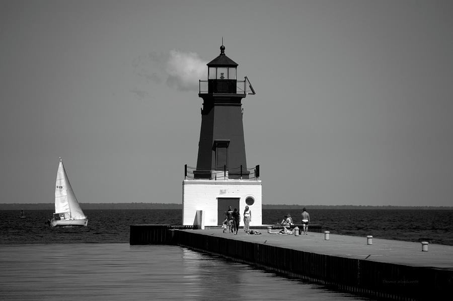 Menominee Pierhead Lighthouse Wisconsin With Sail Boat BW Photograph by Thomas Woolworth