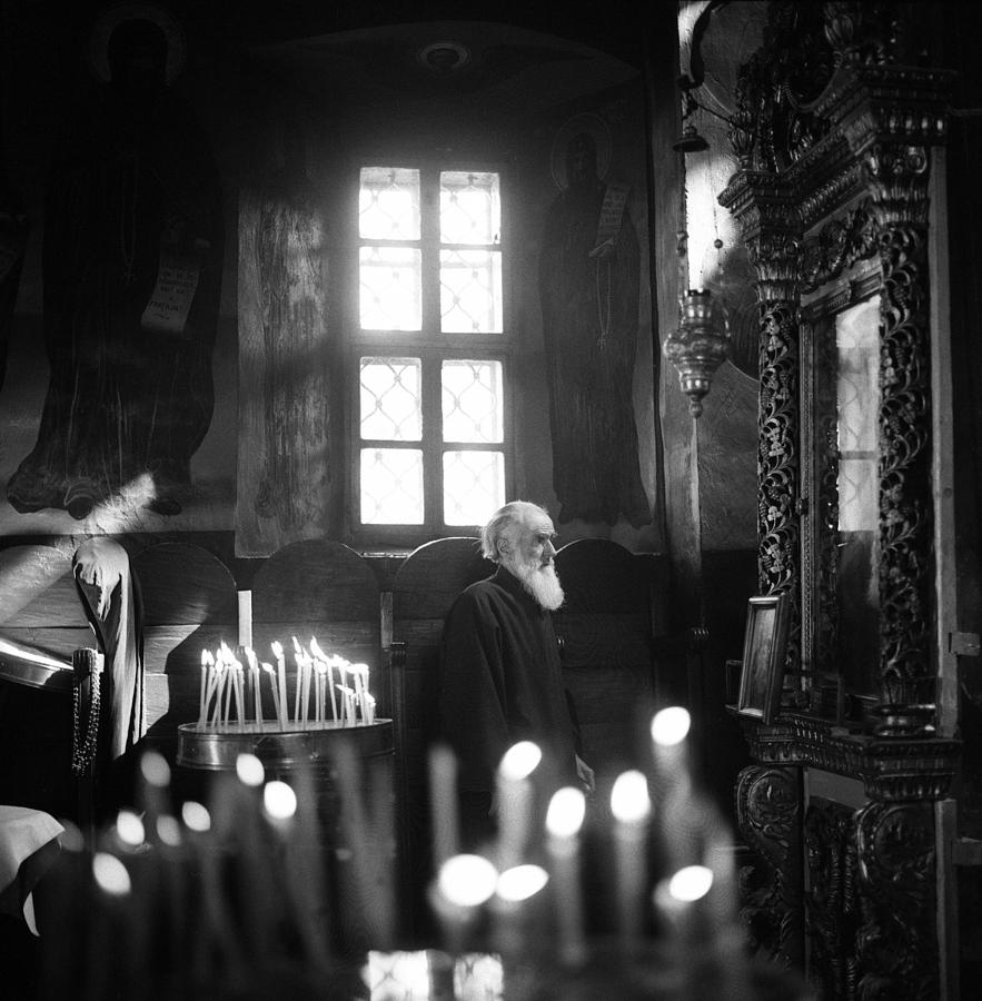 Monk and candles Photograph by Emanuel Tanjala