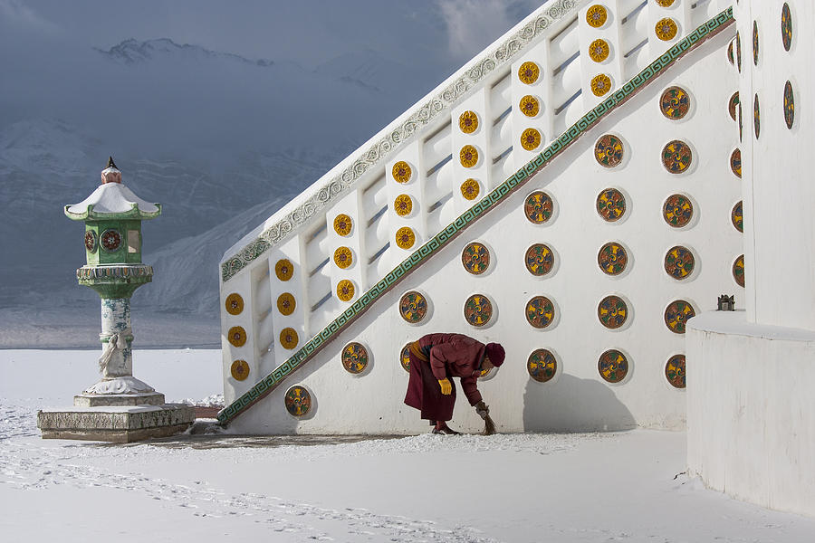 Monk clearing snow Photograph by Hitendra SINKAR