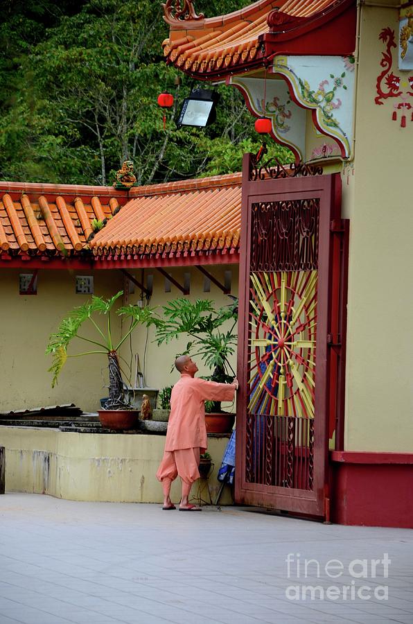 Monk opens main gate and readies Sam Poh Chinese Buddhist temple Cameron Highlands Malaysia Photograph by Imran Ahmed