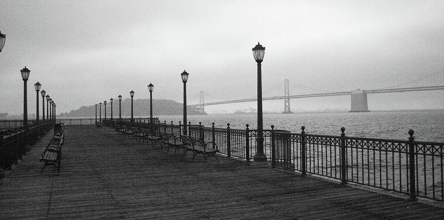 San Francisco Photograph - Monochrome San Francisco Pier overlooking Bay Bridge by Chuck Wedemeier