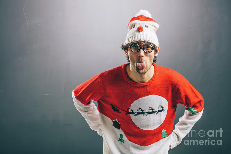 Moody man in funny christmas clothes sticking out his tongue Photograph by Michal Bednarek