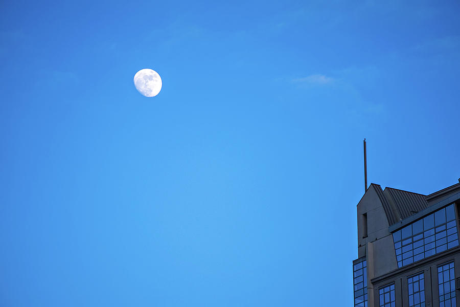 Moon Hovering Over High Rise Building In The City Photograph by Alex Grichenko