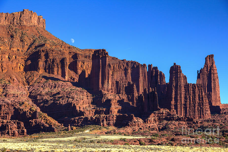 Moon Rising Over The Fisher Towers Photograph by Spencer Baugh