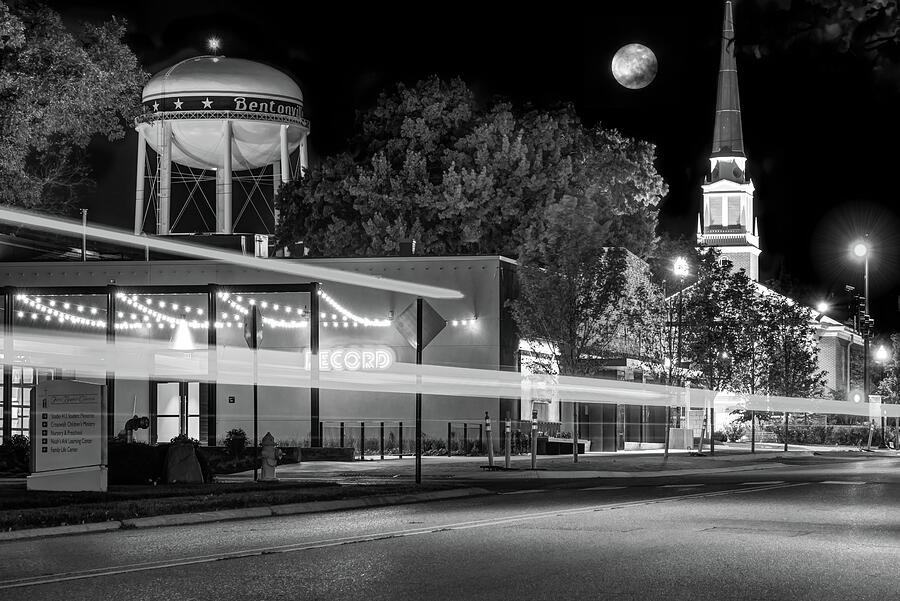 Moonlight Over The Bentonville Record and Water Tower - Black and White Photograph by Gregory Ballos