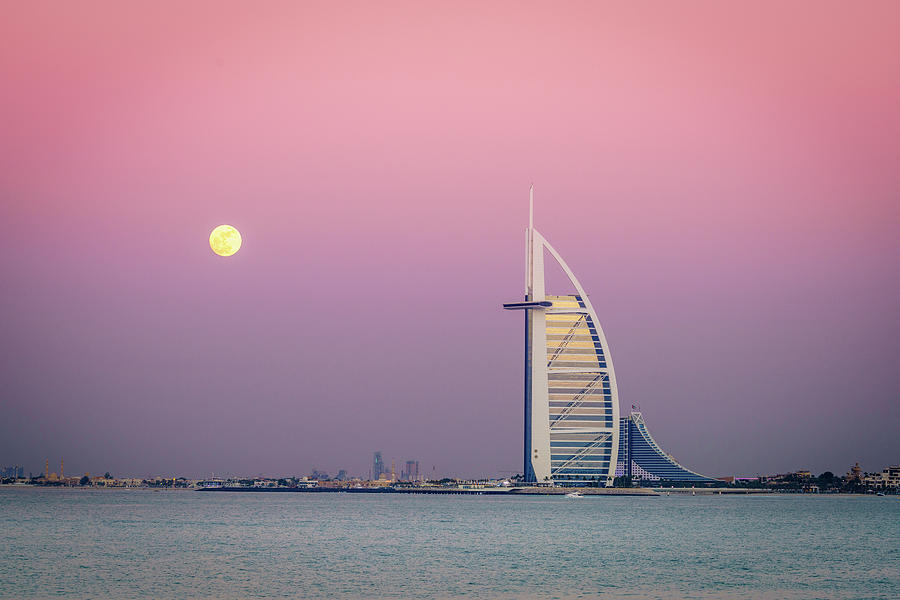 Moonrise over Burj Al Arab Photograph by Alexey Stiop