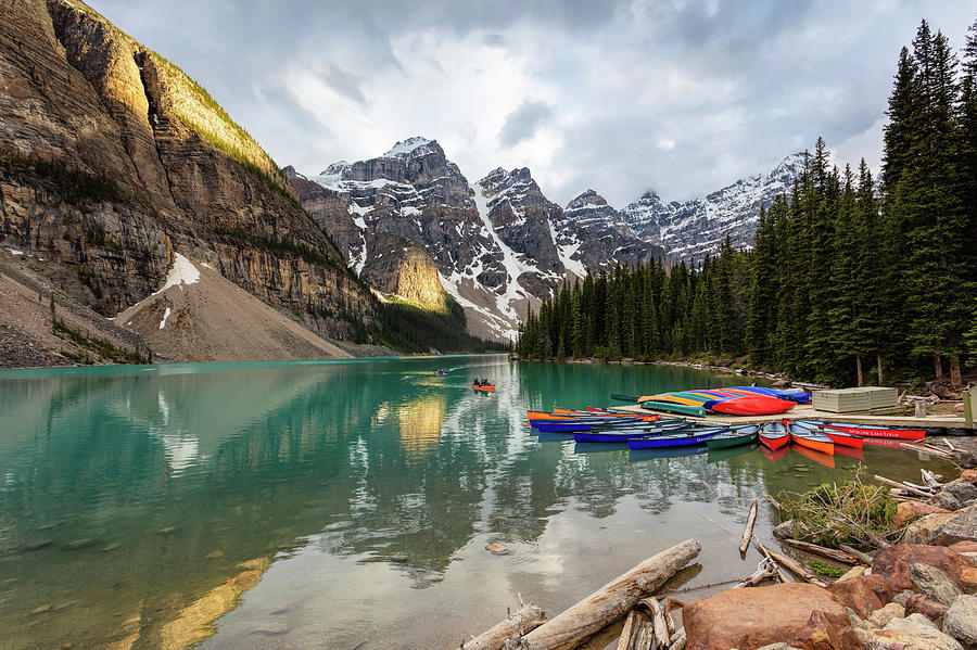 Moraine Lake Canoes Photograph by Mike Centioli