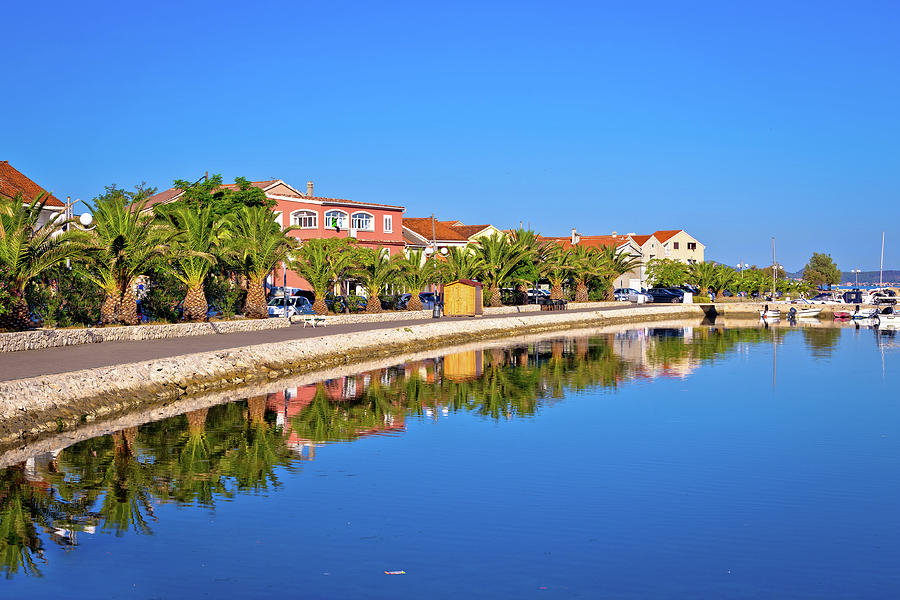 Morning reflections of Bibinje village on calm sea Photograph by Brch Photography