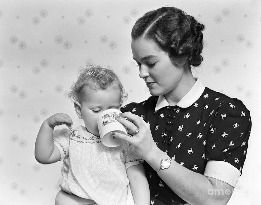 Mother Giving Baby Daughter Drink Photograph by H. Armstrong Roberts/ClassicStock