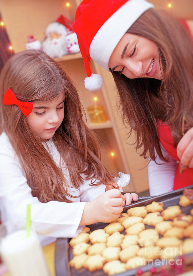 Mother with daughter making Christmas cookies Photograph by Anna Om