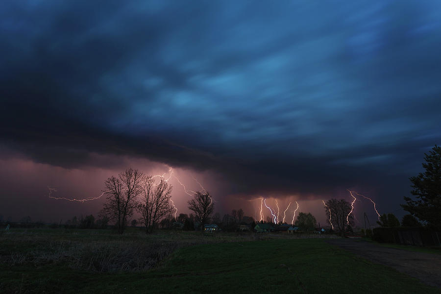 Multiple lightning strikes under dramatic cloudy sky Photograph by ...