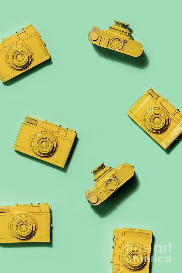 Multiple yellow cameras on green background. Photograph by Michal Bednarek