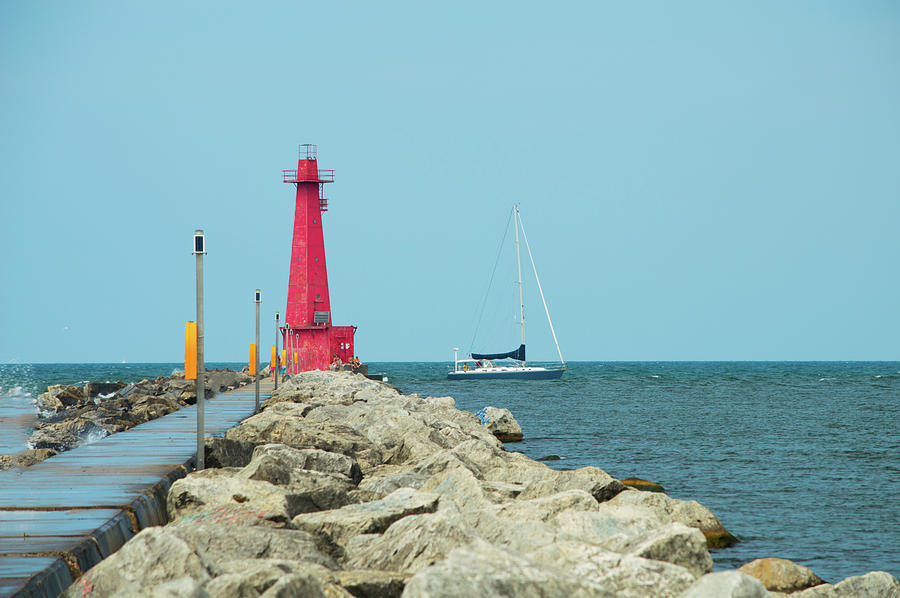 Muskegon Lighthouse and Sailboat in Michigan Photograph by Ken Figurski