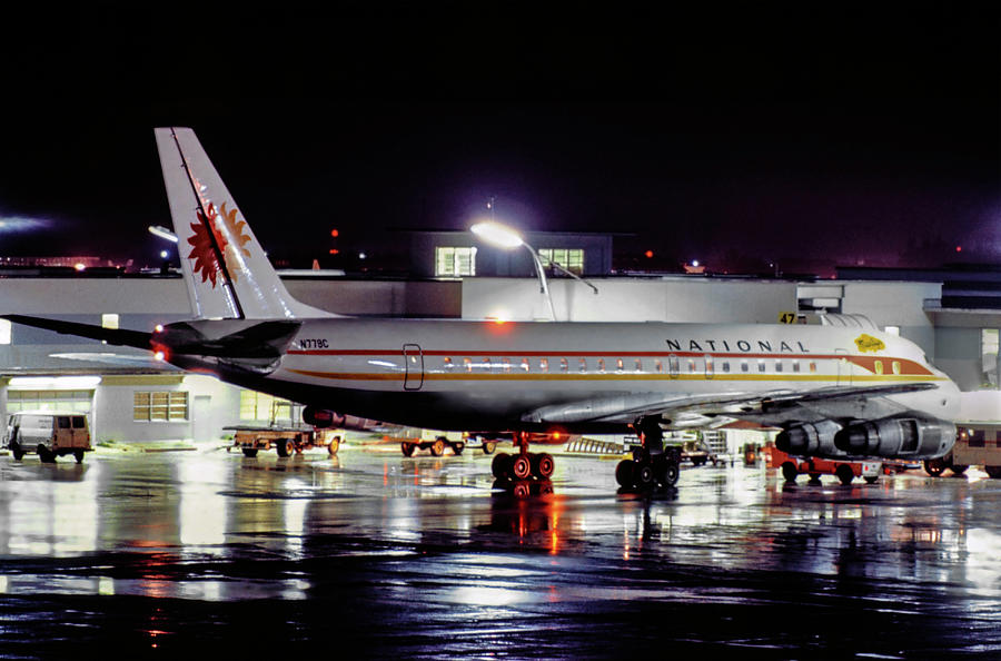 National Airlines DC-8 on a Rainy Night Photograph by Erik Simonsen