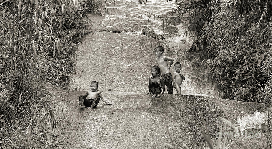 Natures Slide - Vietnamese children. Photograph by Chuck Kuhn
