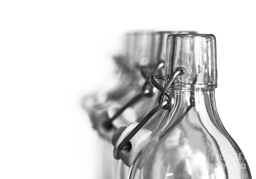 Neck of glass bottles with a porcelain stopper Photograph by Michal Boubin