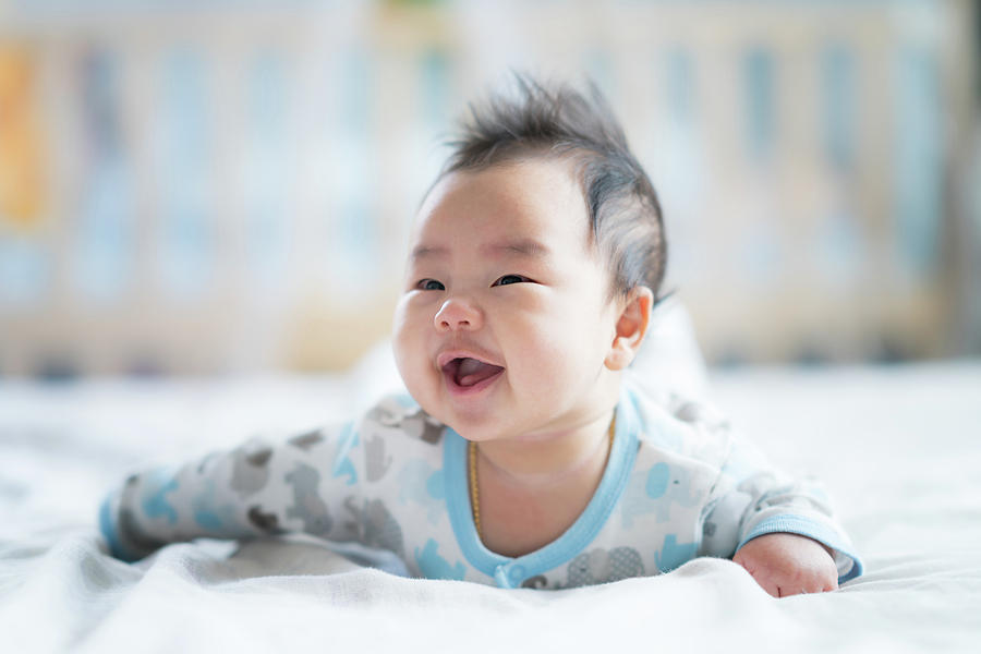 New born boy smile on the bed Photograph by Anek Suwannaphoom