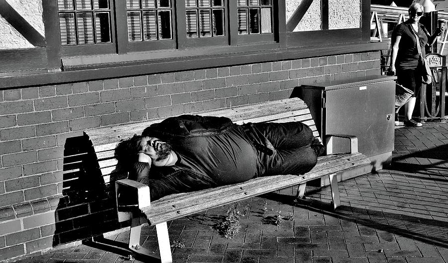 New Zealand - Homeless-Man Glaring-Lady - Black and White Photograph by Jeremy Hall