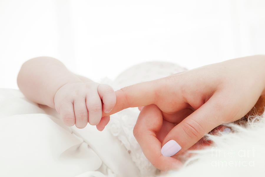 Parenthood Movie Photograph - Newborn baby grasping her mothers finger. Child care, parent love. by Michal Bednarek